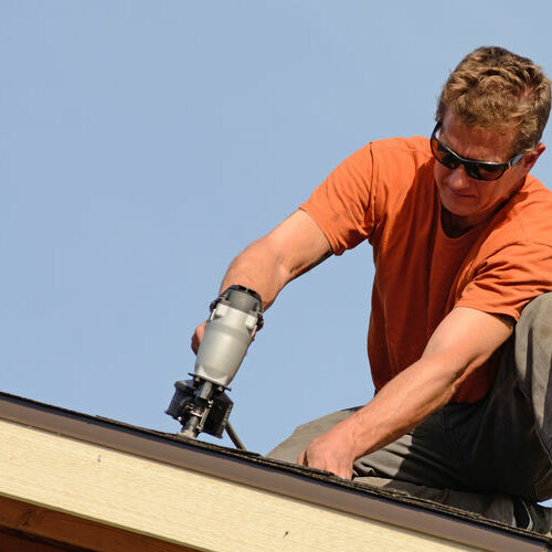 A Roofer Works on a Roof Repair.