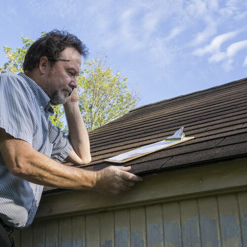 An Insurance Adjuster Inspects a Roof.