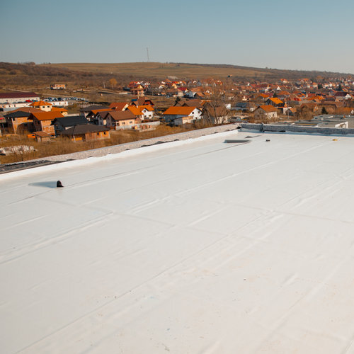 View from above of a flat roof with a white roof coating.